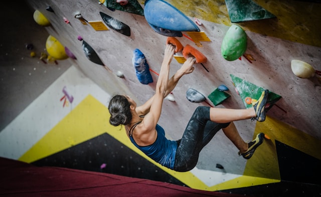 Woman climbing rock wall