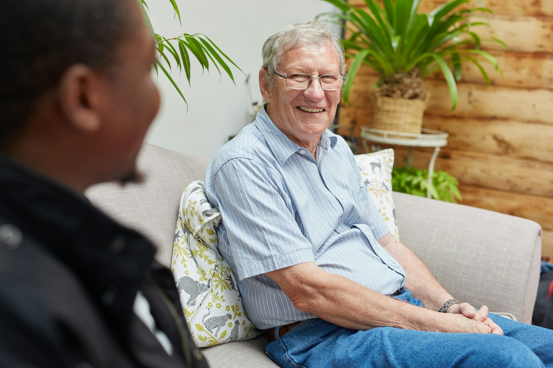 Elderly man smiling with carer